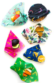 cereal apple, avocado, lemon, and granola bar, each wrapped in reusable beeswax wraps