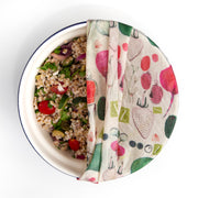 bowl with salad partially covered by a modern designed reusable beeswax wrap