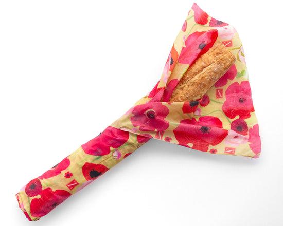 Baguette wrapped in a large flower-patterned beeswax wrap.