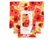 three reusable food wraps in colorful red and pink poppy motif