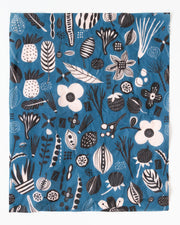 blue beeswax food wrap with white and black flowers and fruits design
